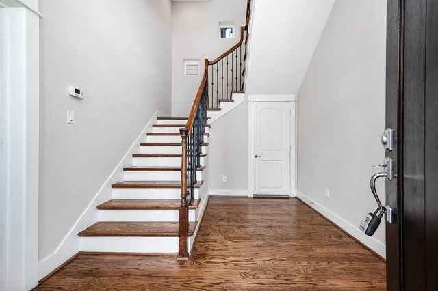 a view of an entryway with wooden floor and staircase