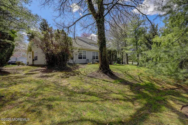 a view of a house with backyard and a garden