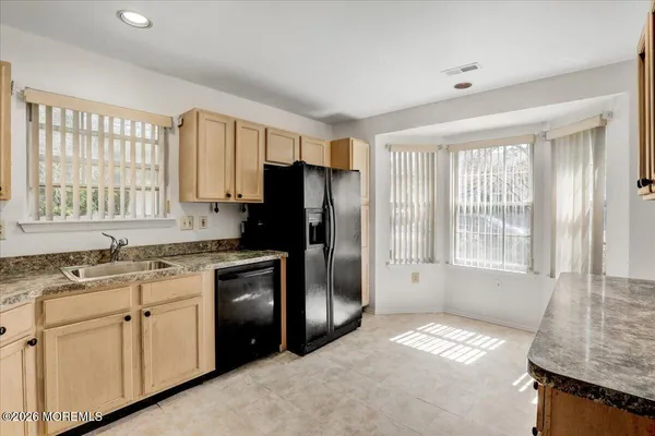 a kitchen with a sink stove and refrigerator