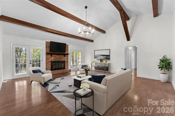 a living room with furniture a fireplace and a flat screen tv