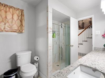 2133 Pleasant Drive Dallas, TX 75227 - Photo 16 of 40 Full bath with vanity and a marble finish shower