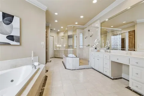 a bathroom with a tub sink and mirror