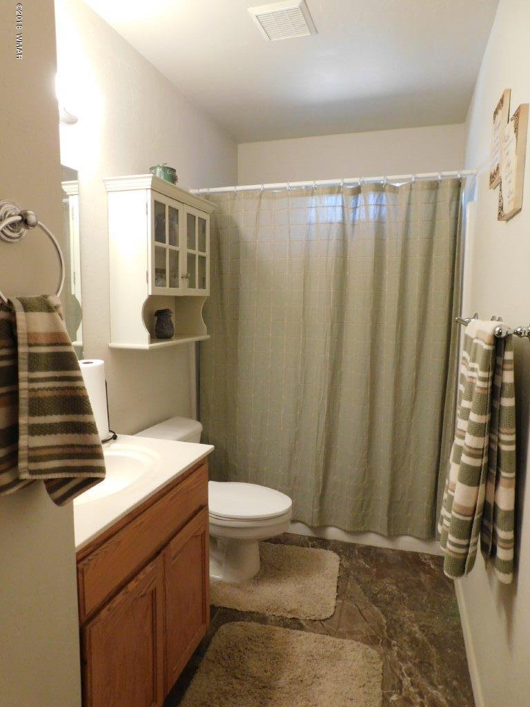 1998 Lexington Overgaard, AZ 85933 - Photo 17 of 28 a bathroom with a sink a toilet and shower