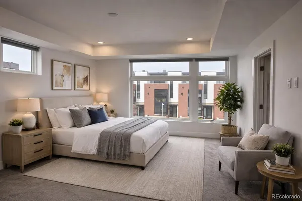 a spacious bedroom with a bed and glass windows