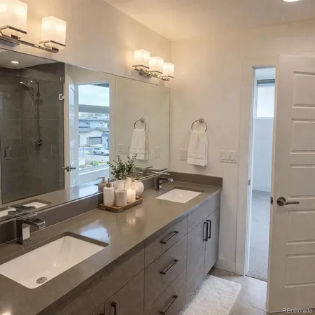 a bathroom with a double vanity sink and mirror
