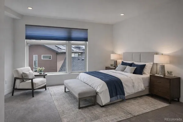 a spacious bedroom with a bed and a couch