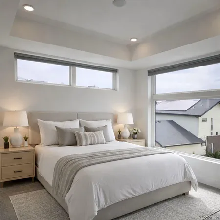 a bedroom with a bed and a large window