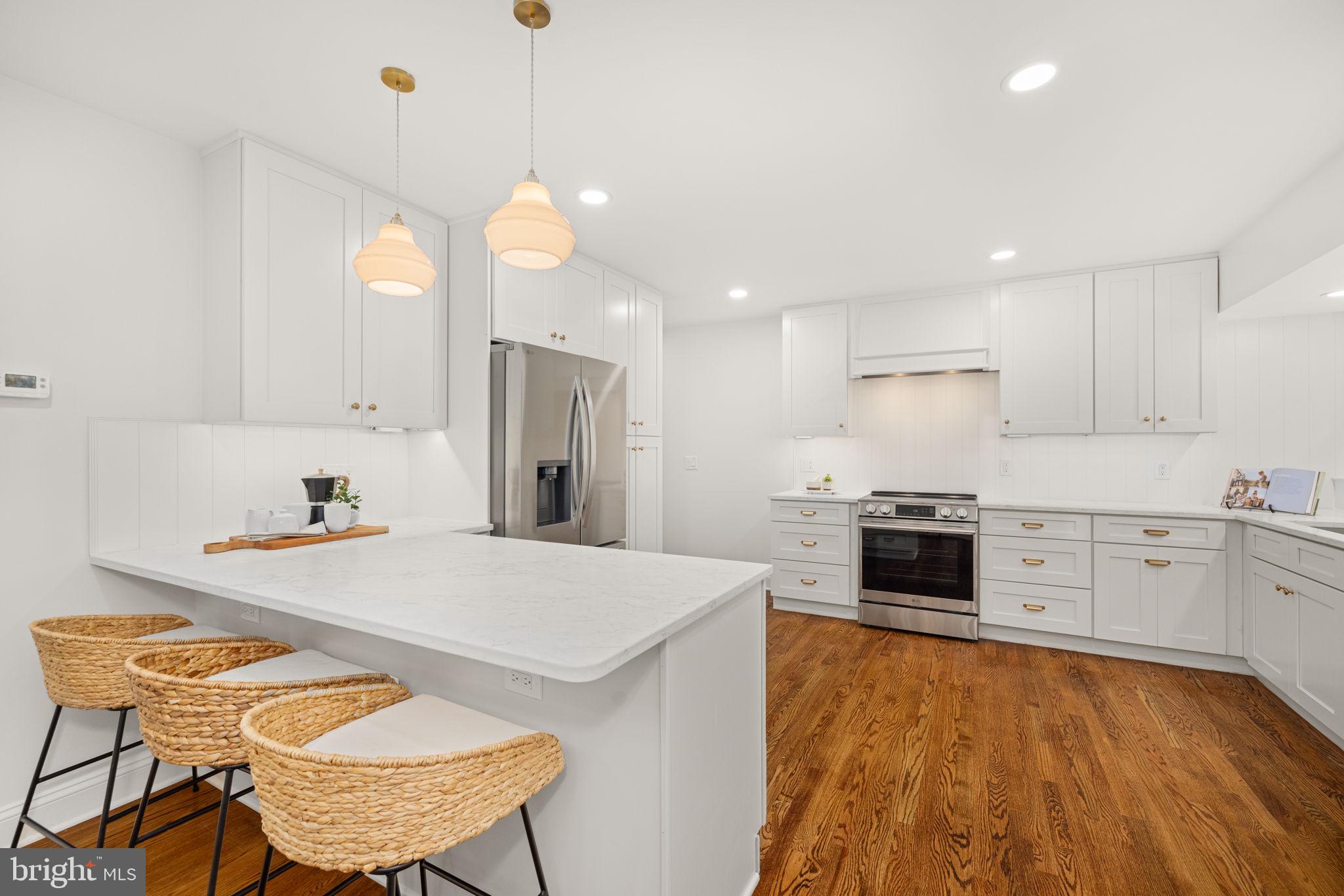 8415 Riverside Road Alexandria, VA 22308 - Photo 13 of 44 a kitchen with stainless steel appliances granite countertop a stove a sink a microwave oven a refrigerator with white cabinets and wooden floor