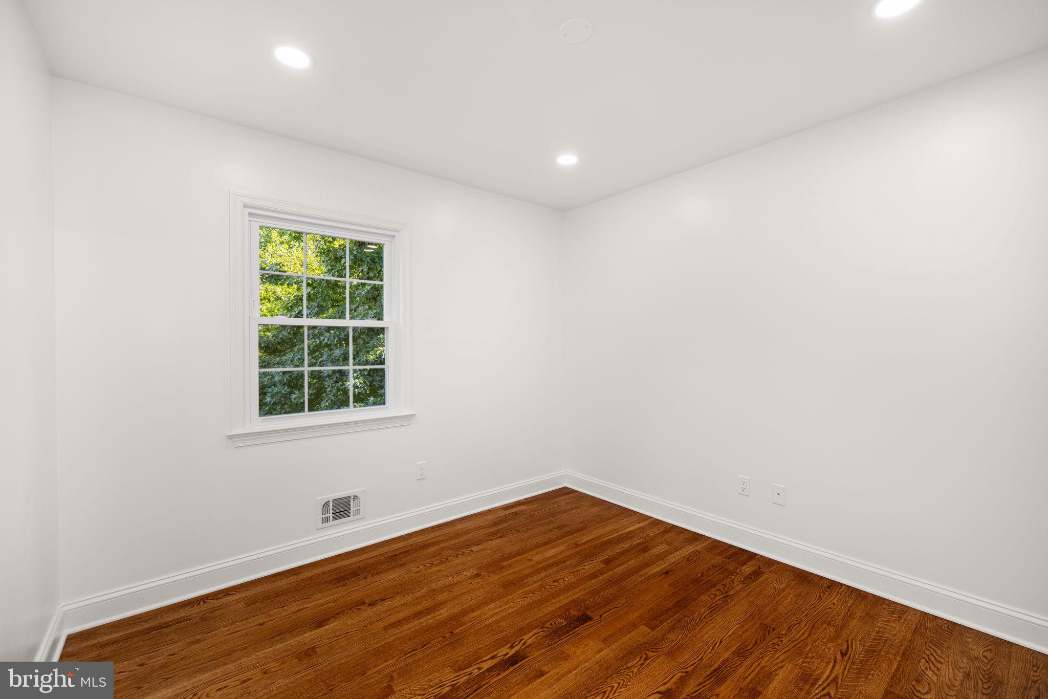 8415 Riverside Road Alexandria, VA 22308 - Photo 25 of 44 an empty room with wooden floor and windows