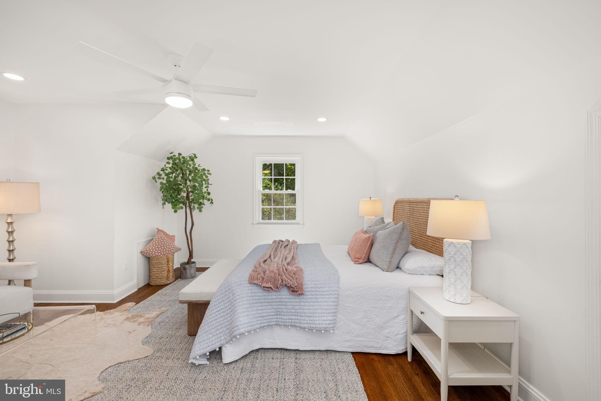 8415 Riverside Road Alexandria, VA 22308 - Photo 27 of 44 a bedroom with a bed and a potted plant