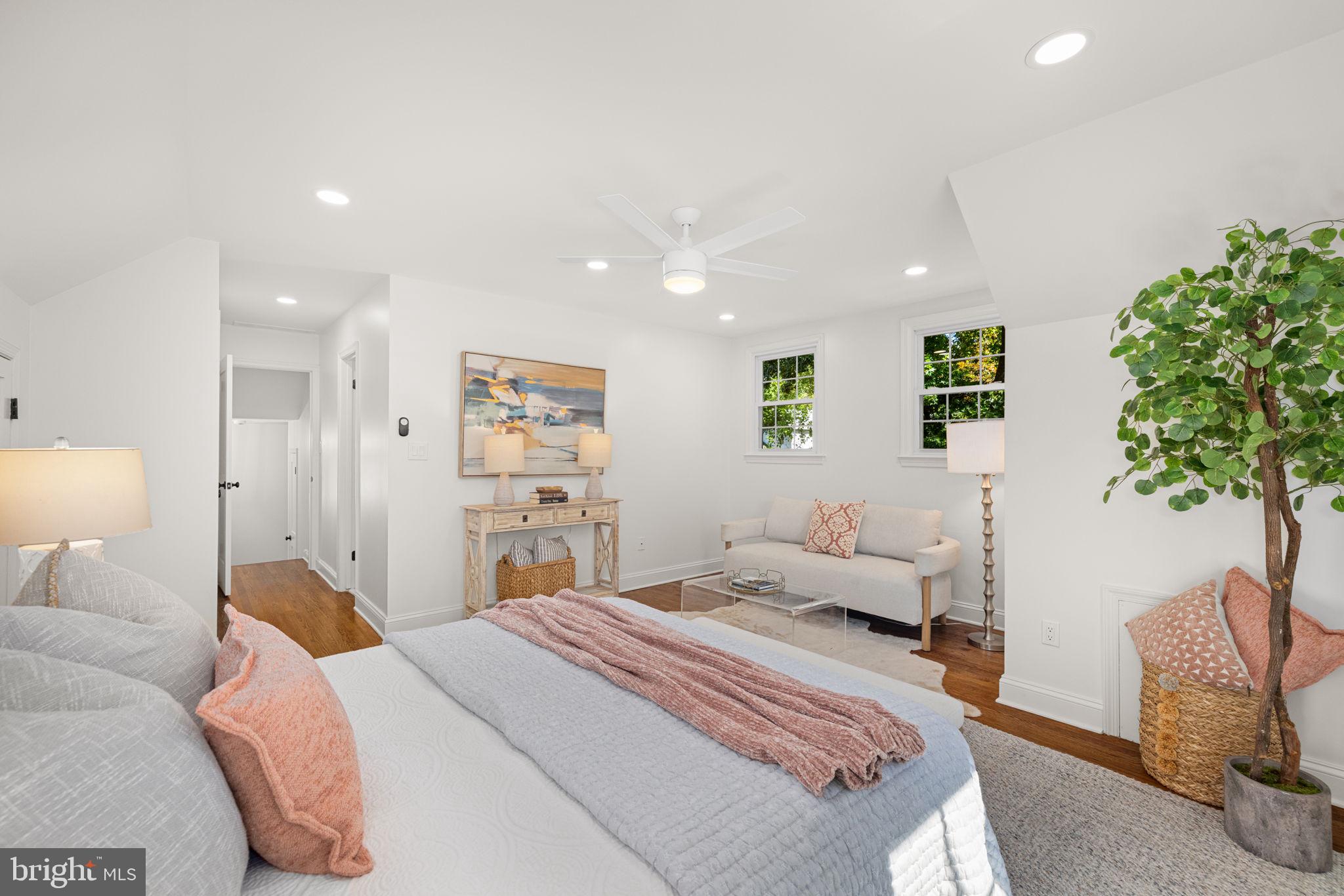 8415 Riverside Road Alexandria, VA 22308 - Photo 30 of 44 a bedroom with a large bed and a potted plant