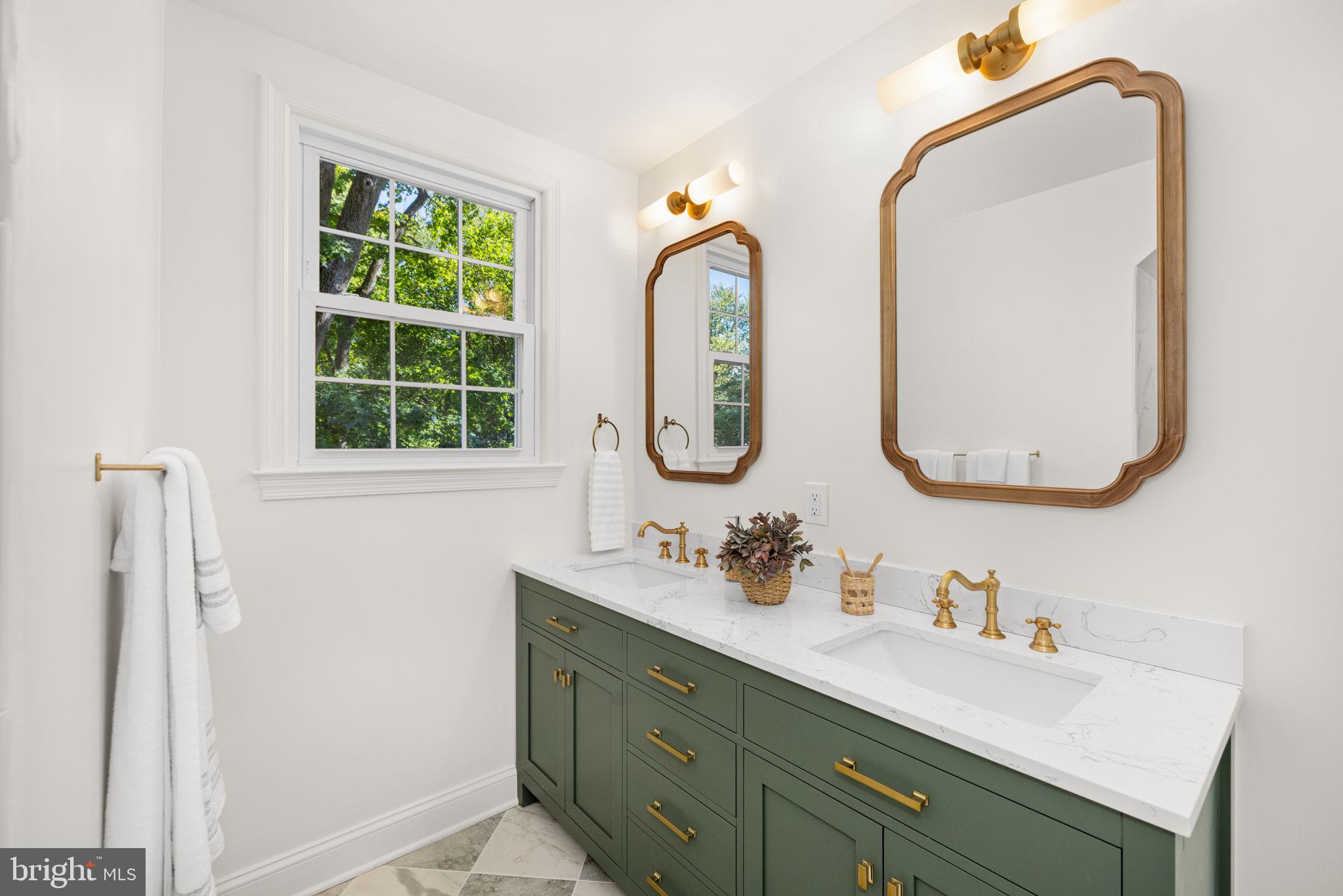 8415 Riverside Road Alexandria, VA 22308 - Photo 32 of 44 a bathroom with double vanity sinks and a mirror
