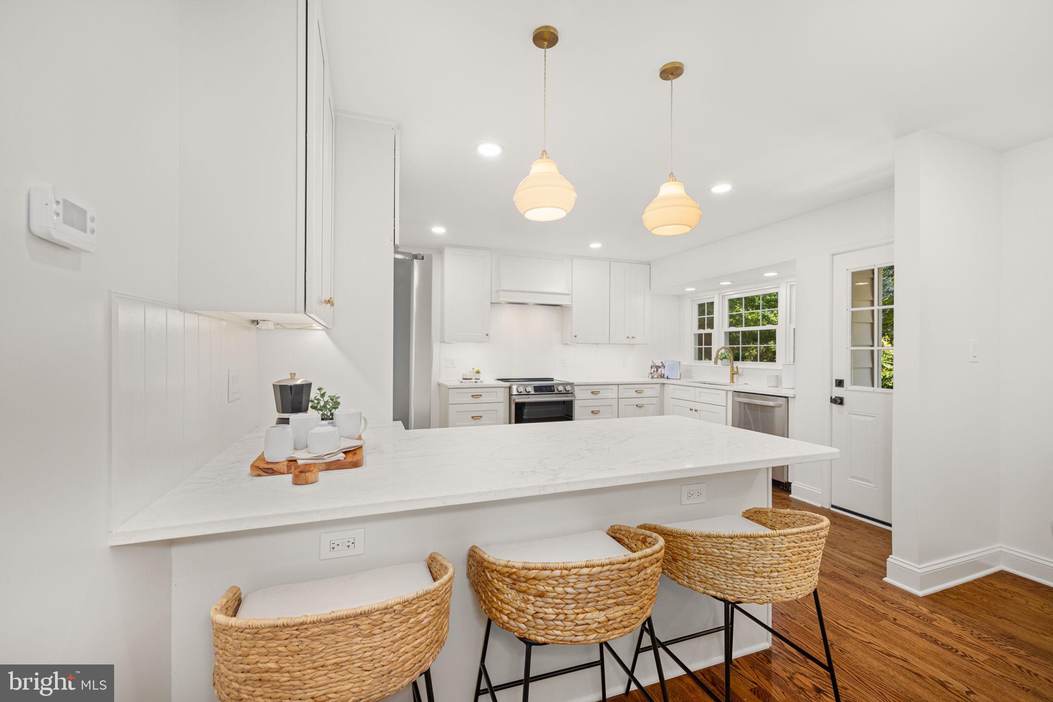 8415 Riverside Road Alexandria, VA 22308 - Photo 8 of 44 a large white kitchen with a table and chairs
