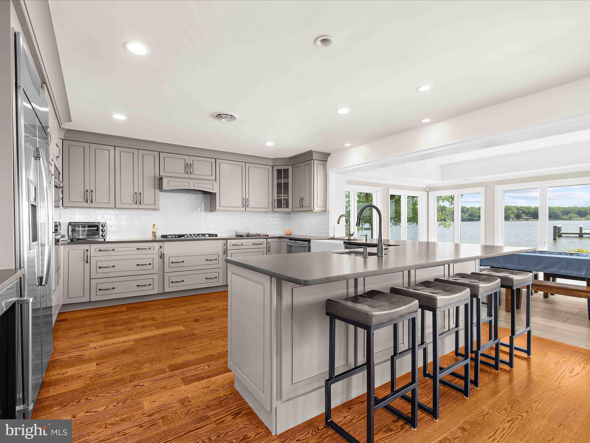 7961 Quaker Neck Road Chestertown, MD 21620 - Photo 14 of 93 a kitchen with stainless steel appliances granite countertop a stove top oven a sink a dining table and chairs