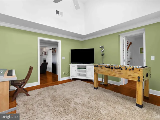 a view of staircase with wooden floor and a rug