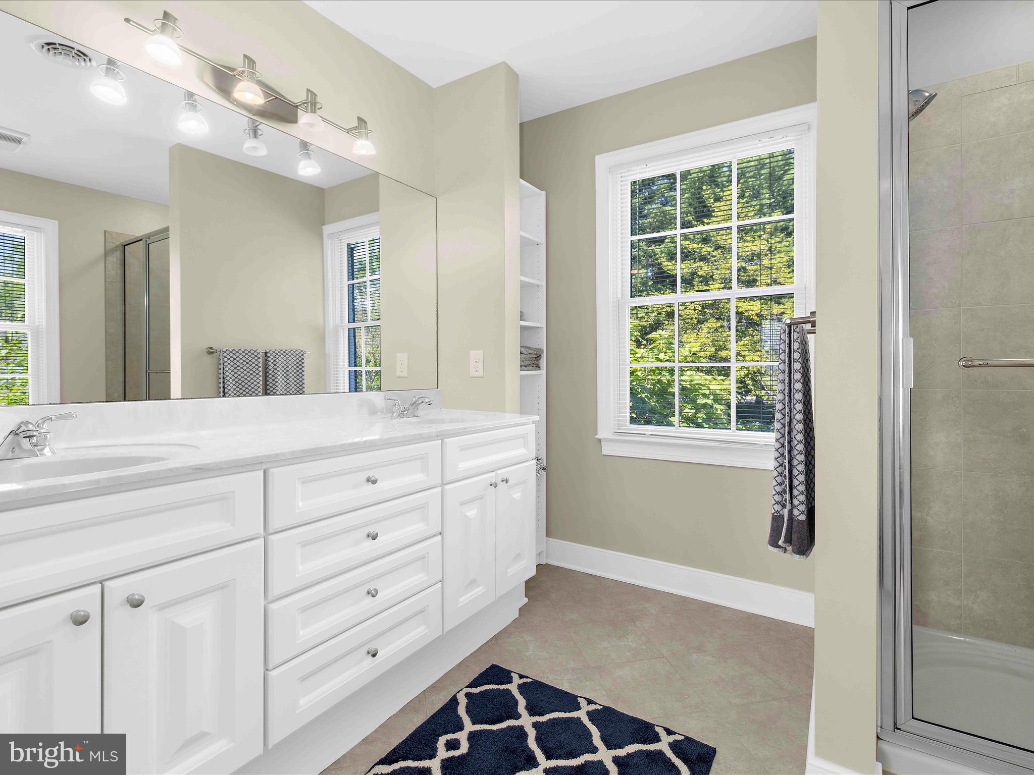 7961 Quaker Neck Road Chestertown, MD 21620 - Photo 34 of 93 a bathroom with a double vanity sink a mirror and a bathtub