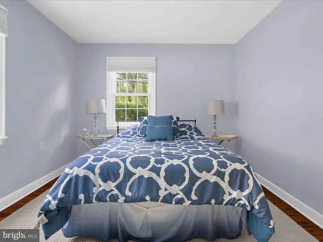 a view of a house with a big yard and large trees