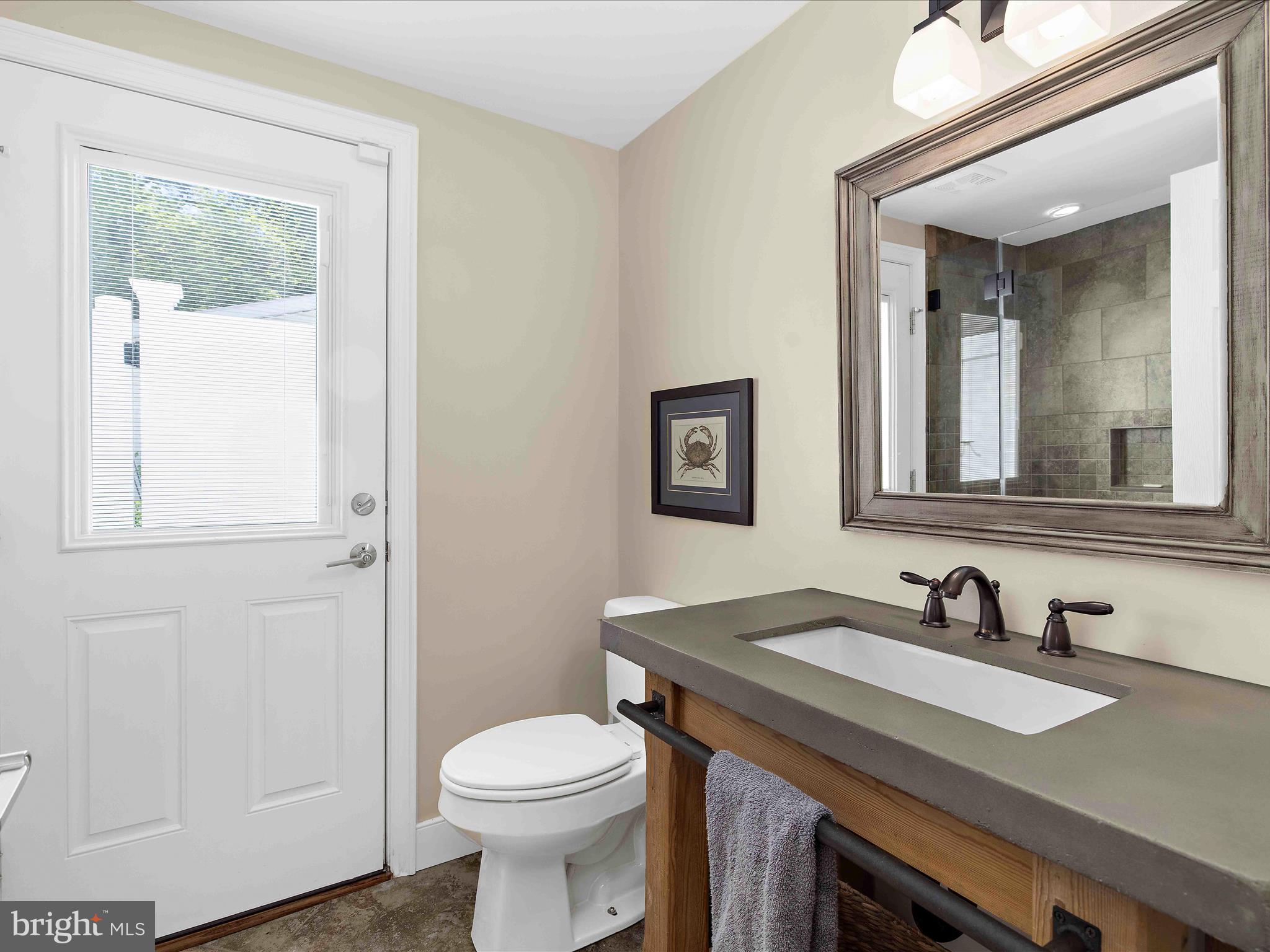 7961 Quaker Neck Road Chestertown, MD 21620 - Photo 44 of 93 a bathroom with a granite countertop sink vanity mirror and toilet