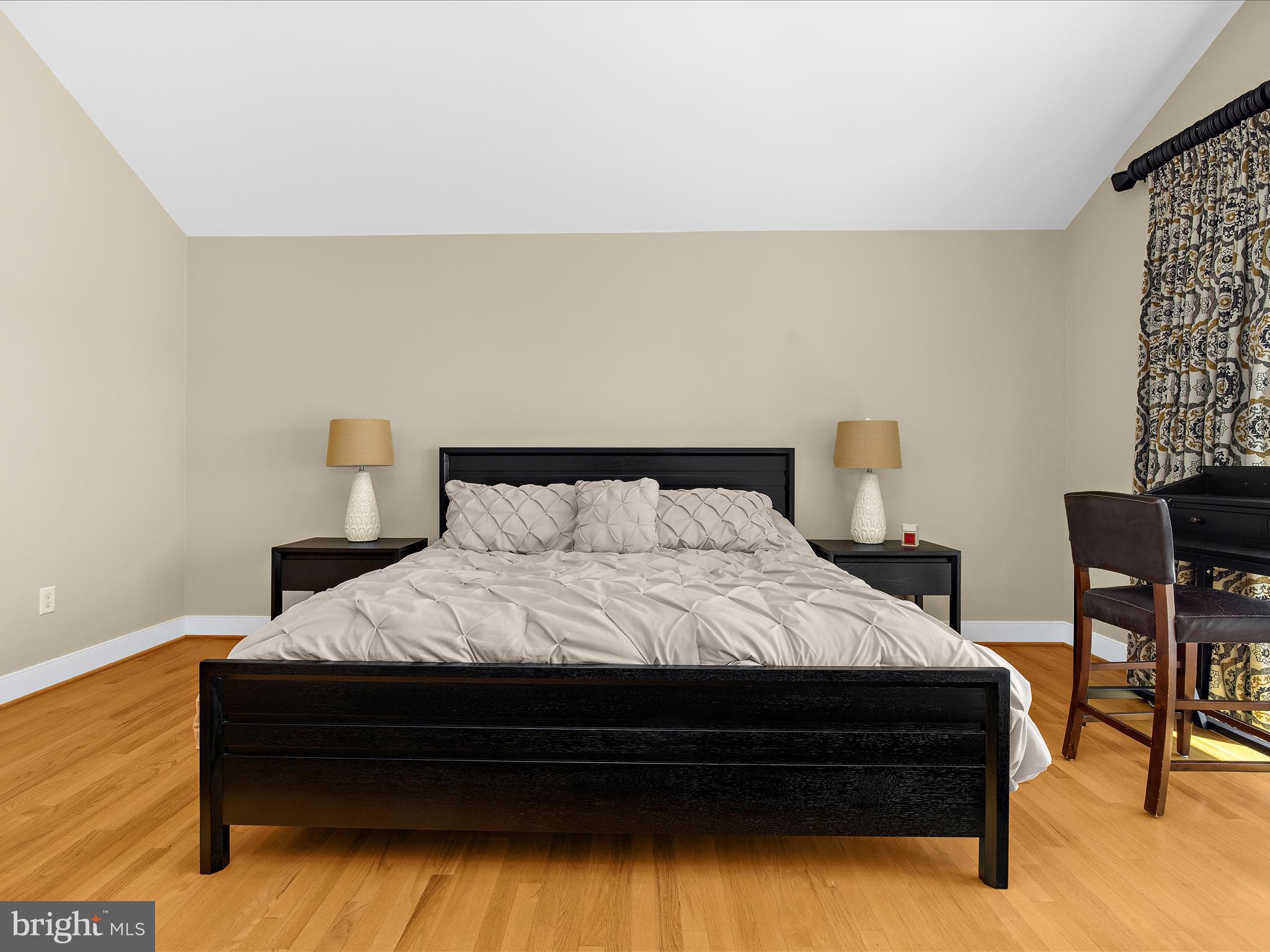 7961 Quaker Neck Road Chestertown, MD 21620 - Photo 54 of 93 a spacious bedroom with a bed and chair