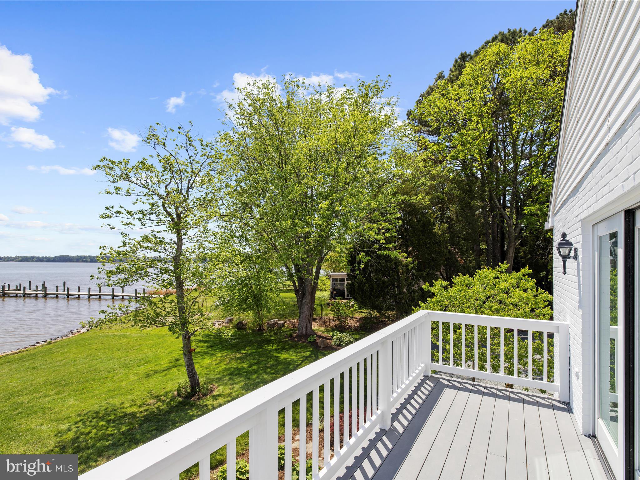 7961 Quaker Neck Road Chestertown, MD 21620 - Photo 56 of 93 a view of a wooden deck with a yard