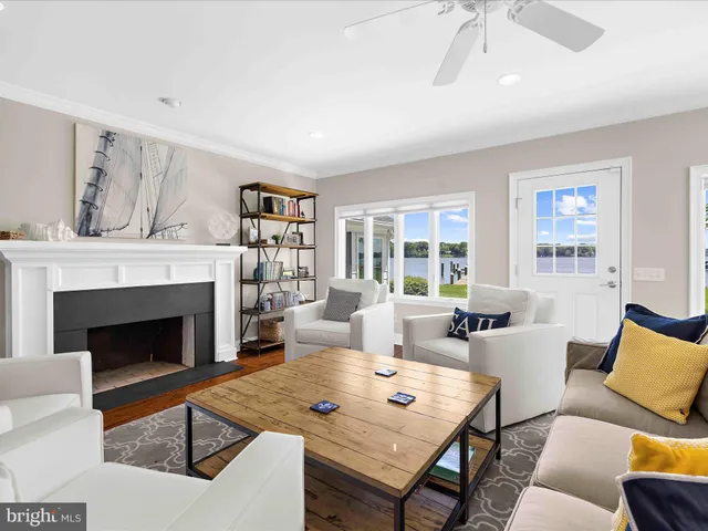 a living room with furniture pool table and a fireplace