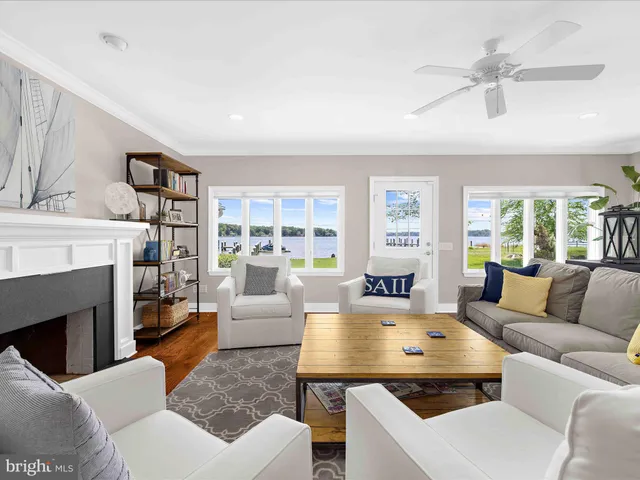 a kitchen with stainless steel appliances granite countertop a stove top oven a sink a dining table and chairs