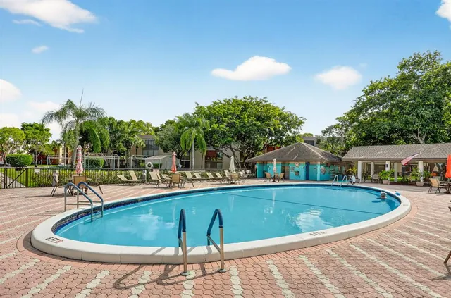 a view of a swimming pool with a patio