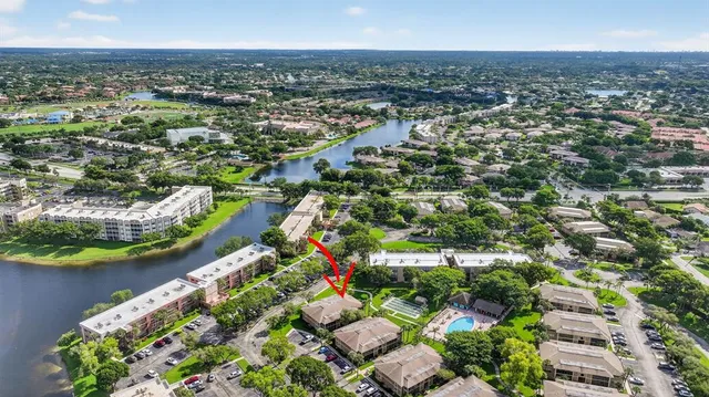 an aerial view of residential houses with outdoor space and swimming pool