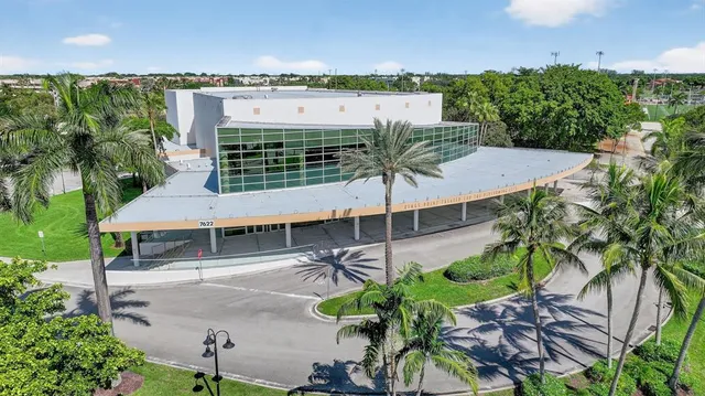 an aerial view of a house with a yard and outdoor seating