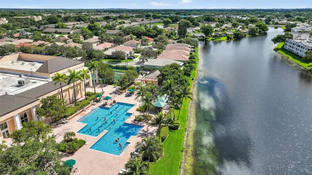 an aerial view of residential houses with outdoor space and lake view