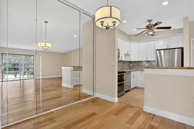 a view of a kitchen with a sink stainless steel appliances and cabinets