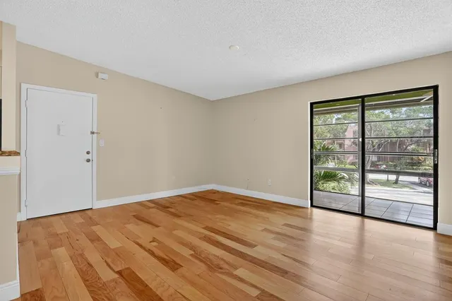 wooden floor in an empty room with window