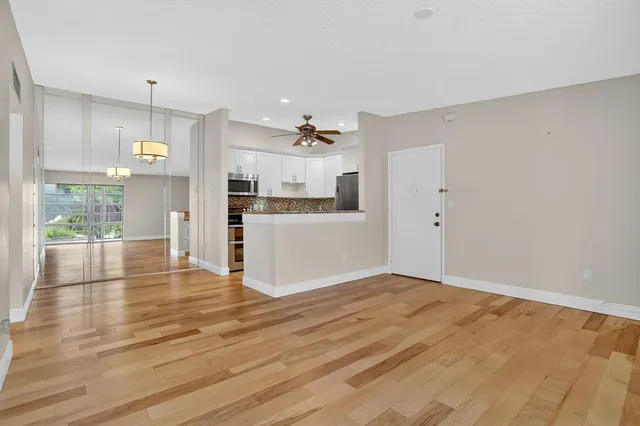 a view of a kitchen with wooden floor and a kitchen