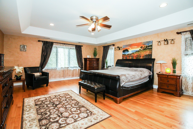 813 Elmdale Road Glenview, IL 60025 - Photo 14 of 26 a bedroom with a bed and wooden floor