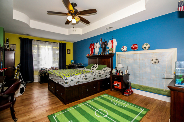 813 Elmdale Road Glenview, IL 60025 - Photo 17 of 26 a bed room with a bed window and a flat screen tv