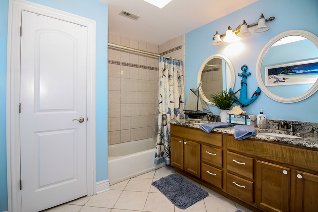 813 Elmdale Road Glenview, IL 60025 - Photo 20 of 26 a bathroom with a double vanity sink and a mirror