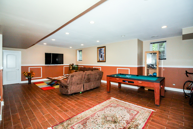 813 Elmdale Road Glenview, IL 60025 - Photo 23 of 26 a living room with furniture and a flat screen tv