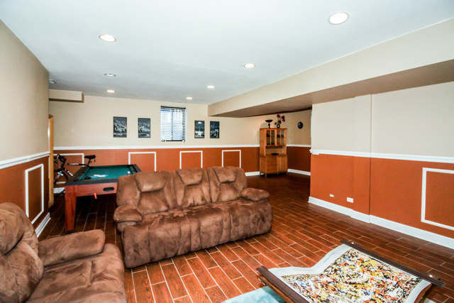 813 Elmdale Road Glenview, IL 60025 - Photo 24 of 26 a living room with a couch and a coffee table