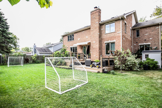 813 Elmdale Road Glenview, IL 60025 - Photo 26 of 26 a view of a house with a backyard and a patio