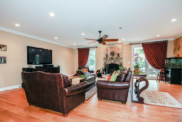 813 Elmdale Road Glenview, IL 60025 - Photo 6 of 26 a living room with furniture a fireplace and a flat screen tv