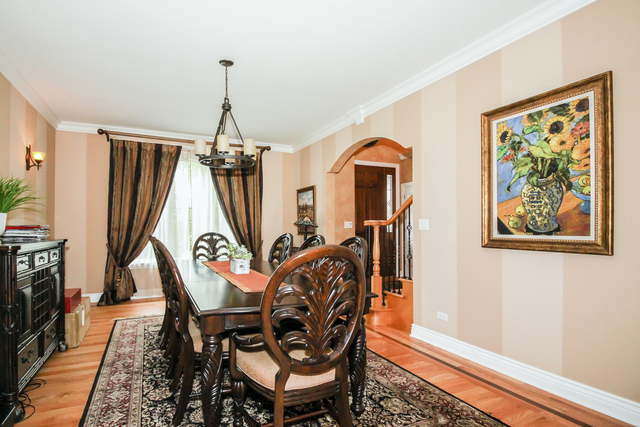 813 Elmdale Road Glenview, IL 60025 - Photo 8 of 26 a dining room with furniture window and wooden floor