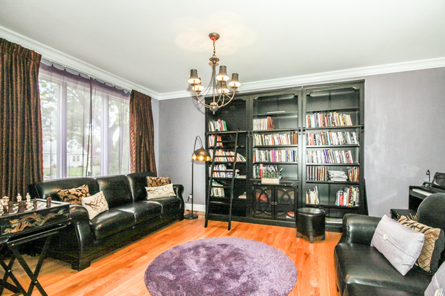 813 Elmdale Road Glenview, IL 60025 - Photo 9 of 26 a living room with furniture fireplace and chandelier