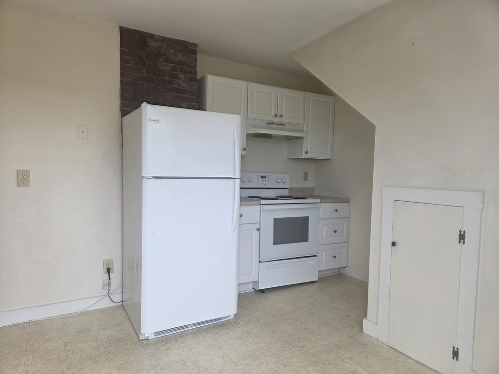 14 Hawkes Street, Unit 2 Marblehead, MA 01945 - Photo 11 of 12 a white refrigerator freezer and a stove sitting inside of a kitchen