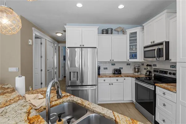 a bedroom with a sink and a large mirror