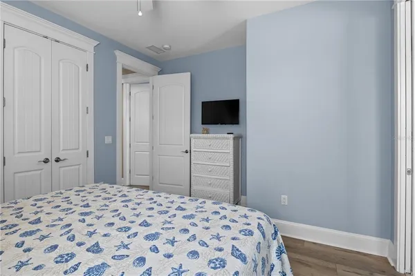 a bedroom with a bed and a chandelier