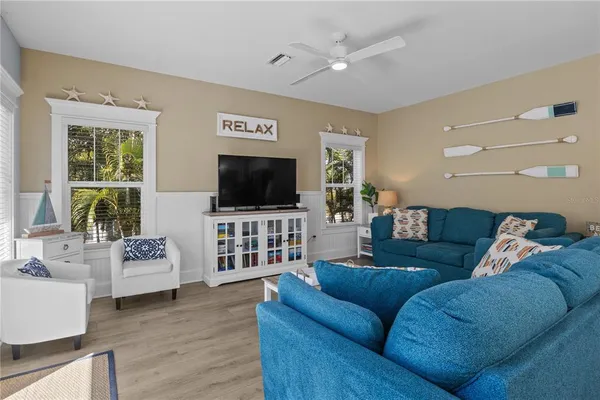 a living room with furniture and a view of kitchen