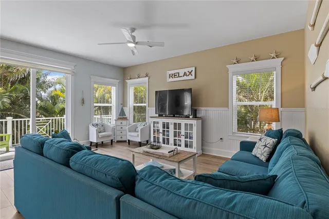 a living room with furniture fireplace and dining table