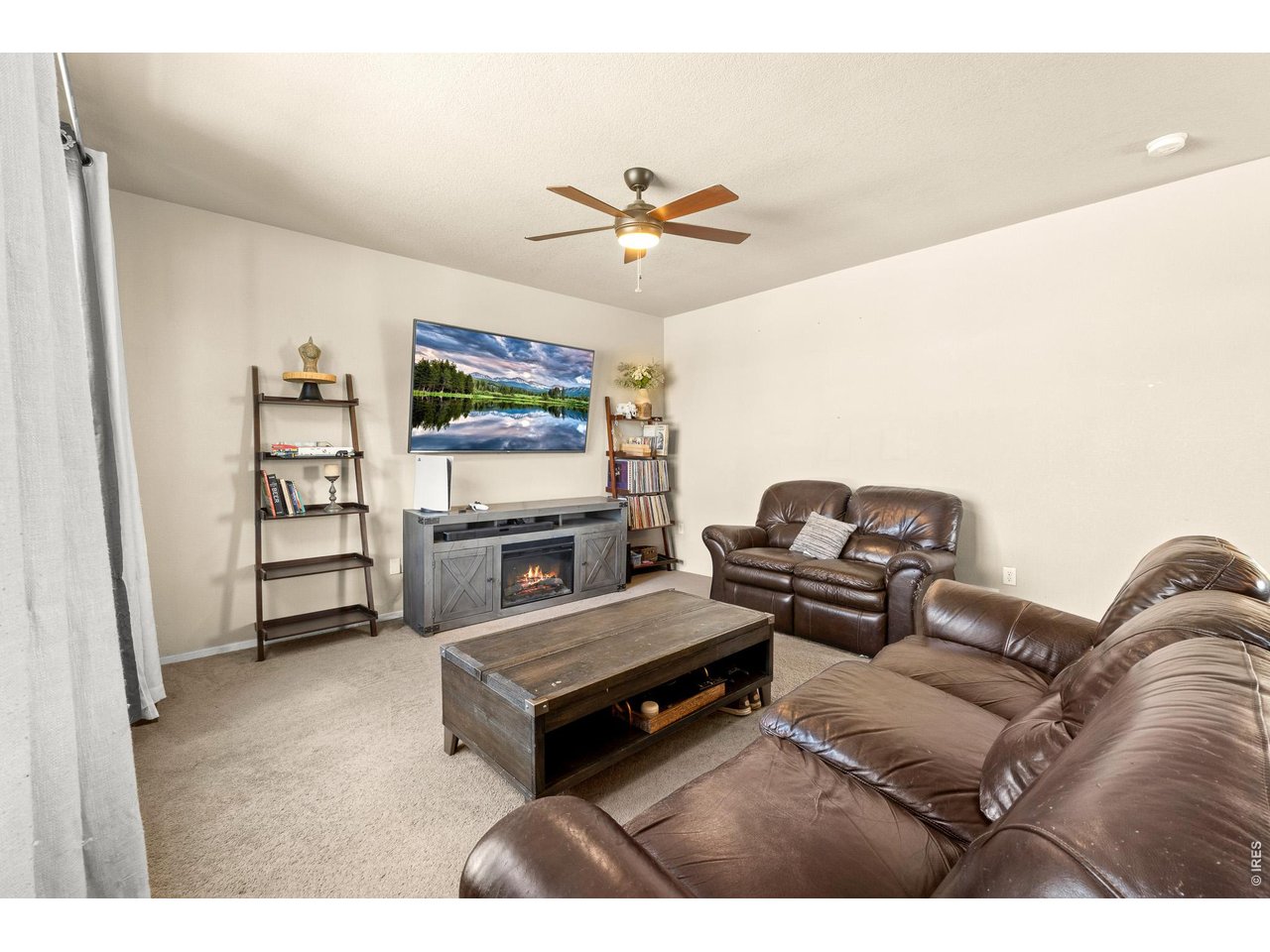 8847 16th St Road Greeley, CO 80634 - Photo 7 of 38 a living room with furniture and a flat screen tv