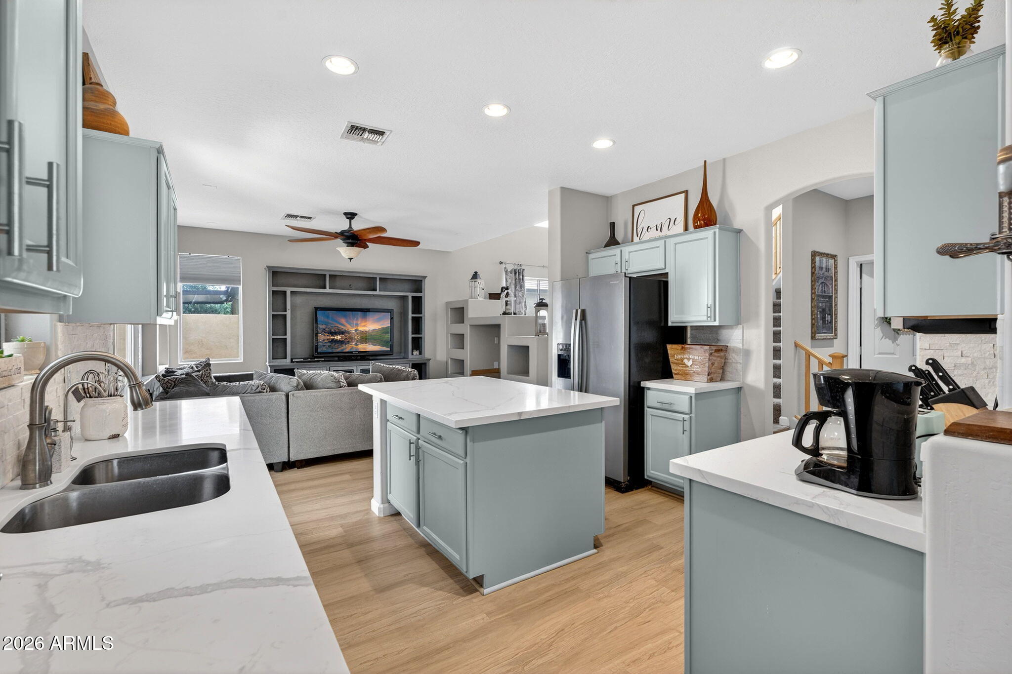 6280 South Sinova Court Gilbert, AZ 85298 - Photo 18 of 64 a kitchen with counter top space a sink stainless steel appliances and cabinets