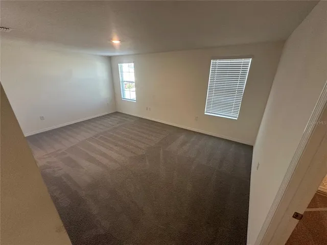 a view of a hallway to rooms